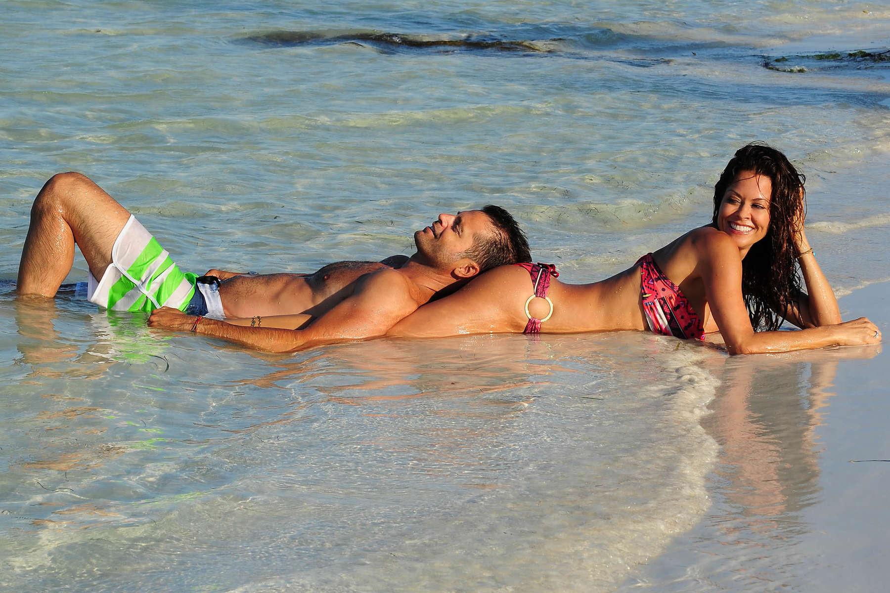 16P Brooke Burke doing a bikini photoshoot on a beach in Mexico