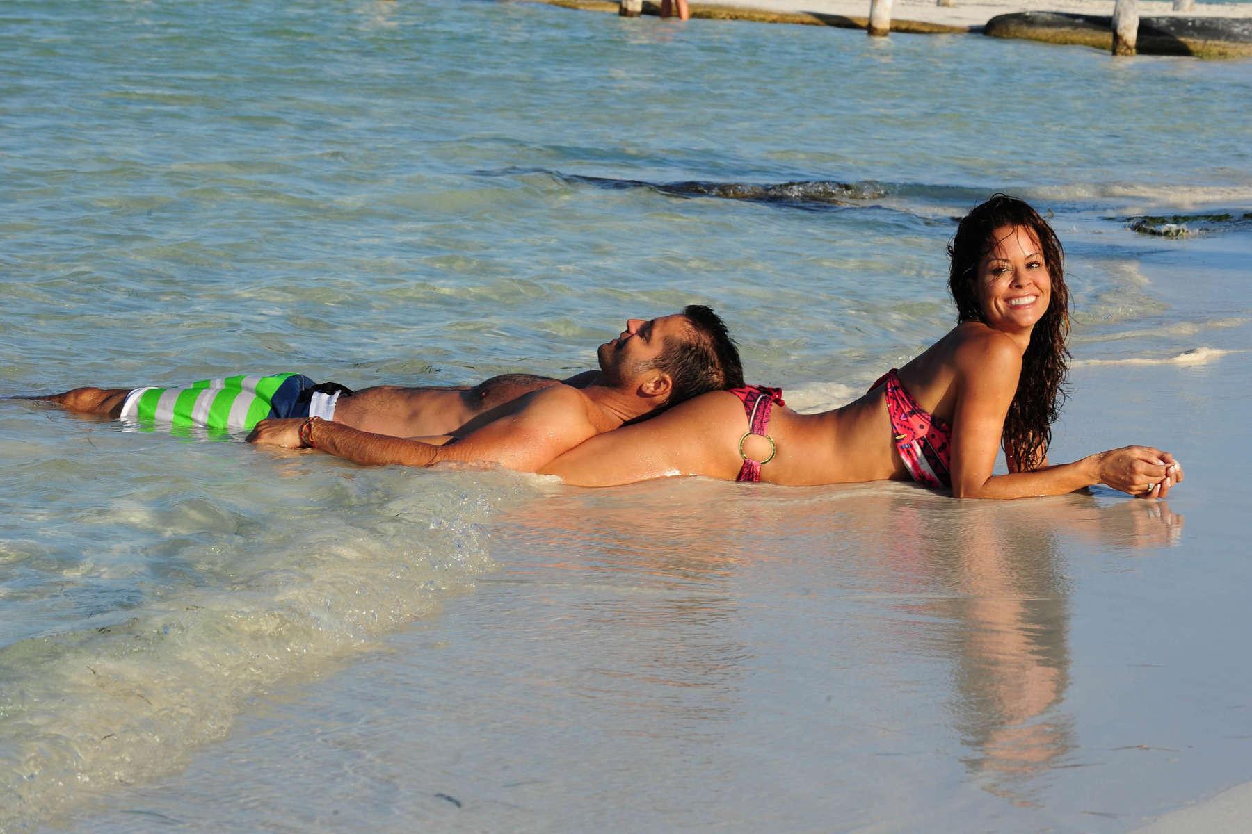 16P Brooke Burke doing a bikini photoshoot on a beach in Mexico