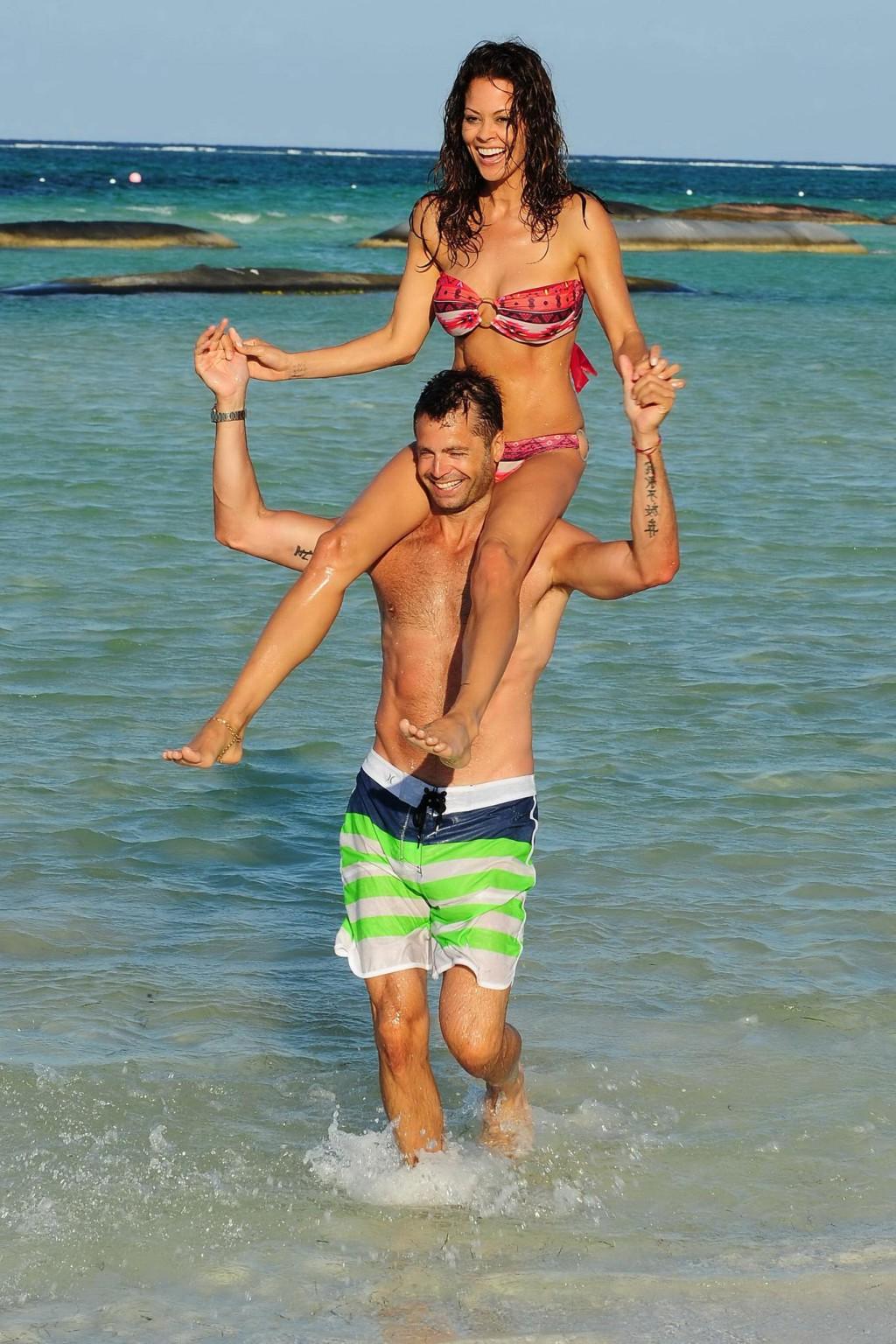 16P Brooke Burke doing a bikini photoshoot on a beach in Mexico