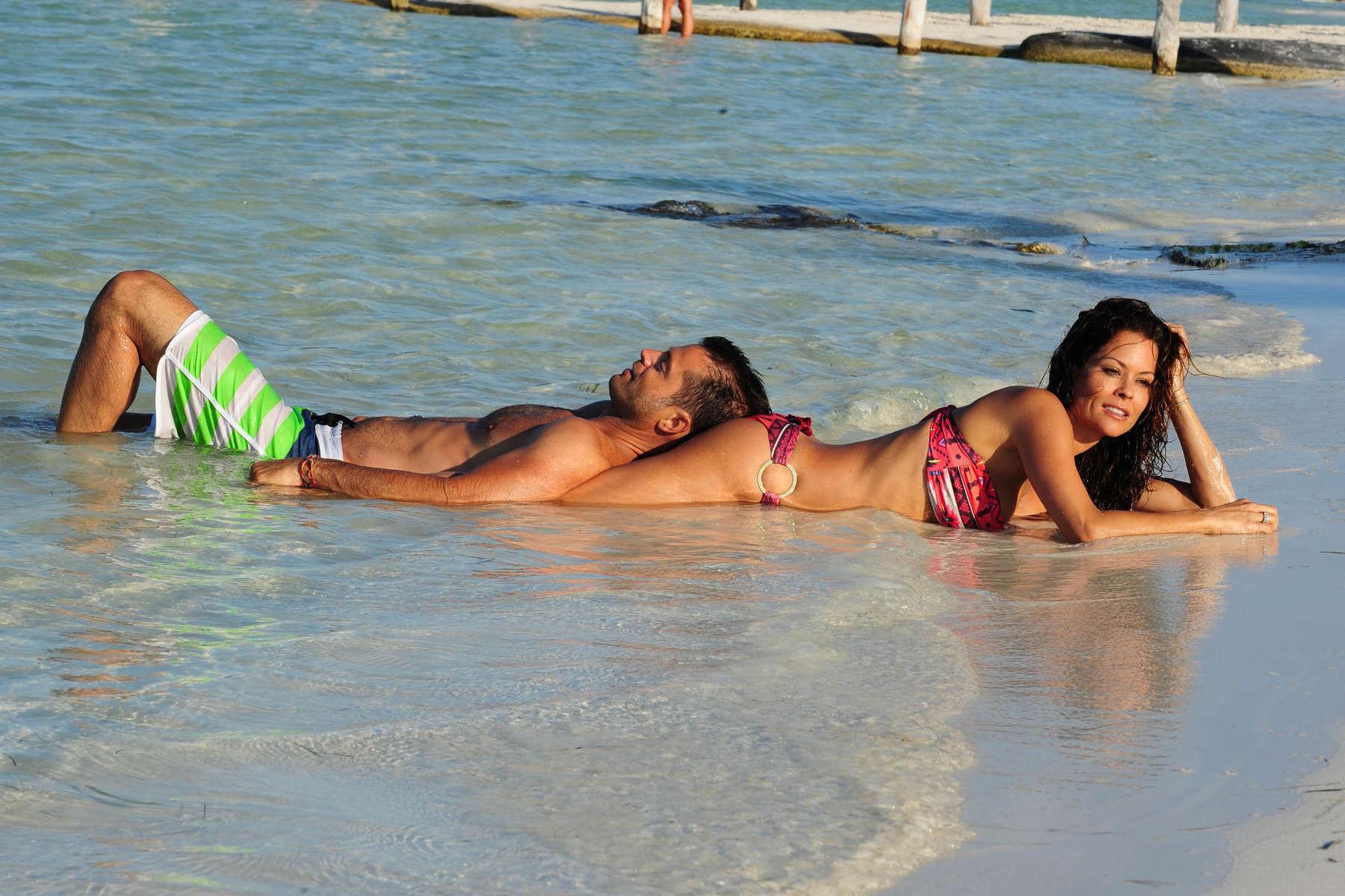 16P Brooke Burke doing a bikini photoshoot on a beach in Mexico