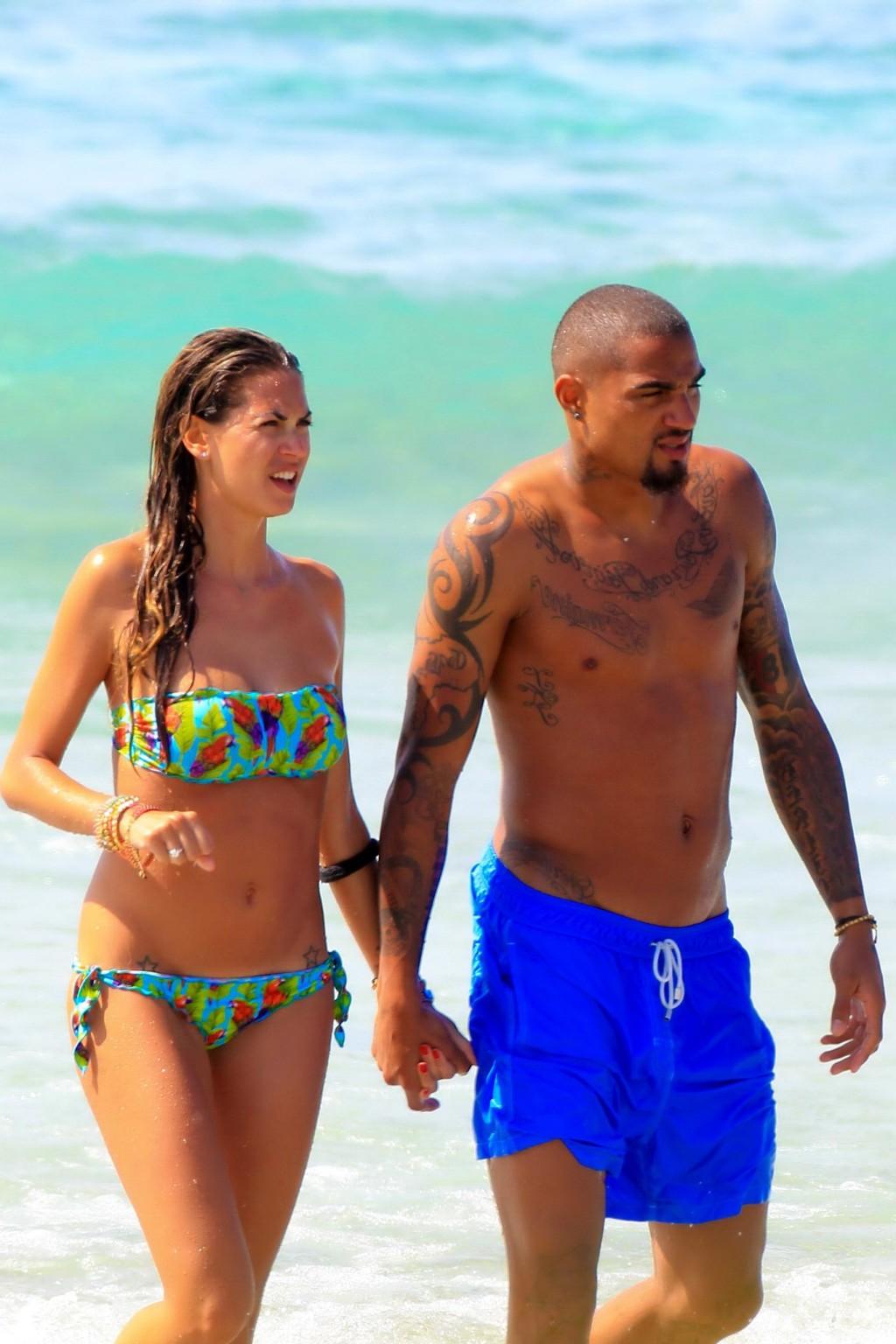 16P Busty Melissa Satta wearing a tube bikini on a beach in Ibiza