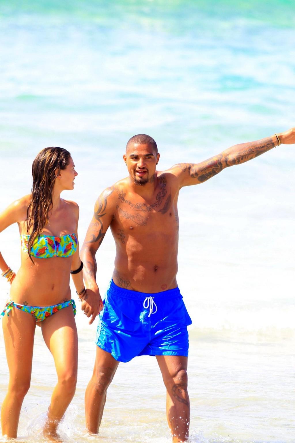 16P Busty Melissa Satta wearing a tube bikini on a beach in Ibiza