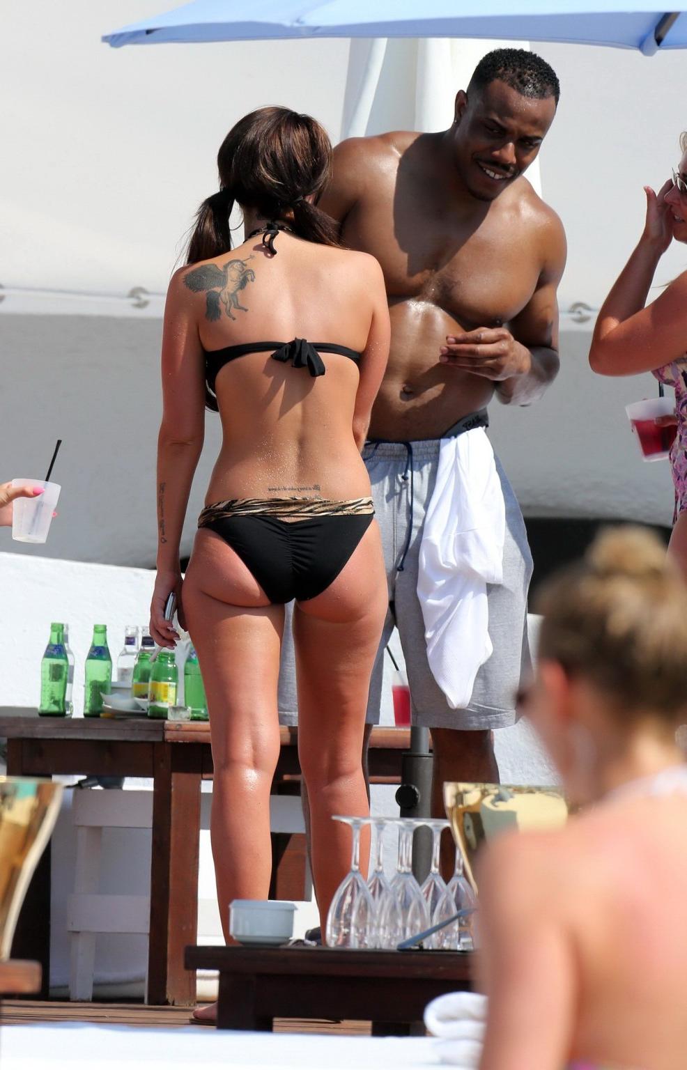 16P Tulisa Contostavlos wearing a tiger print bikini on a beach in Marbella, Spain