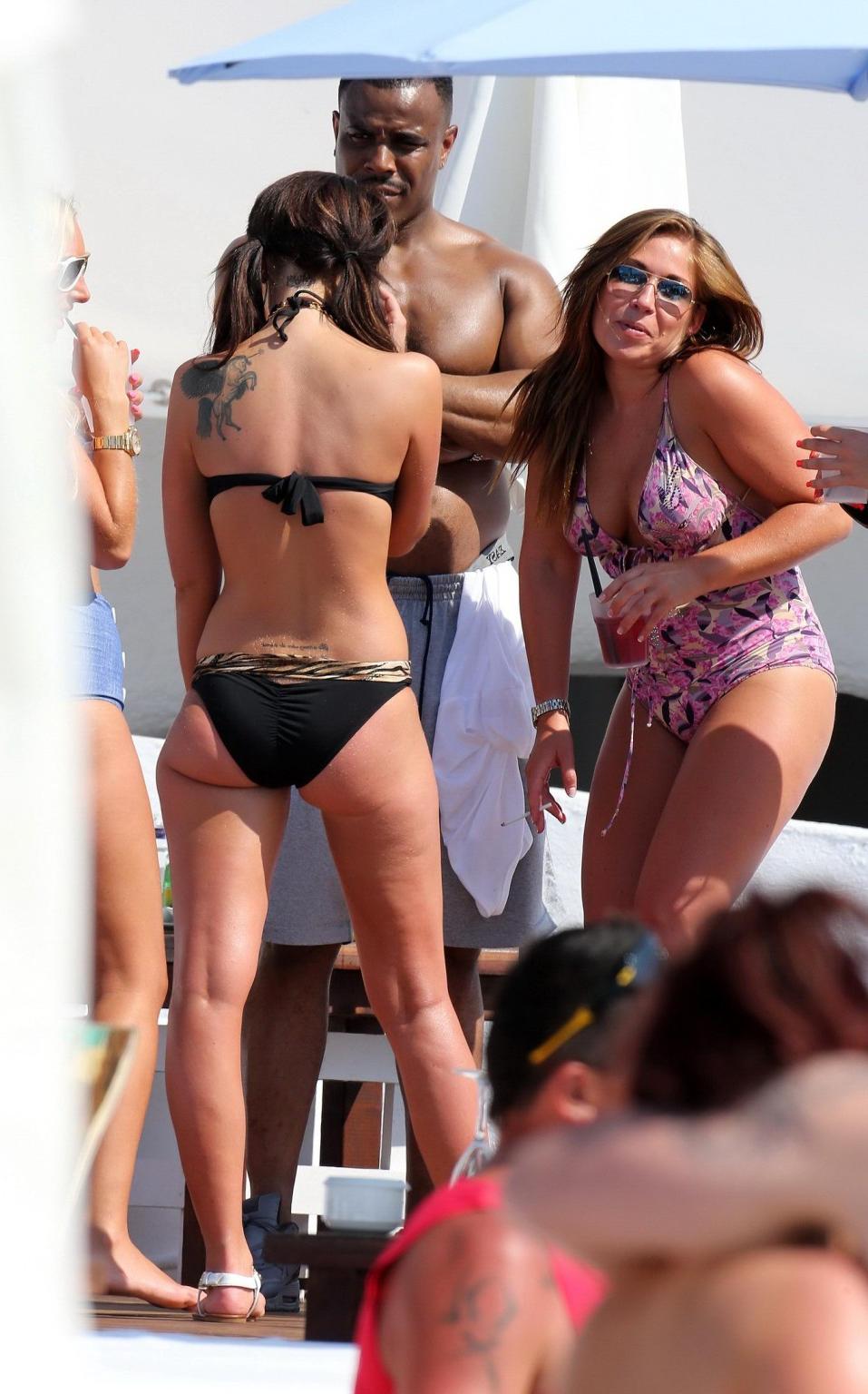 16P Tulisa Contostavlos wearing a tiger print bikini on a beach in Marbella, Spain