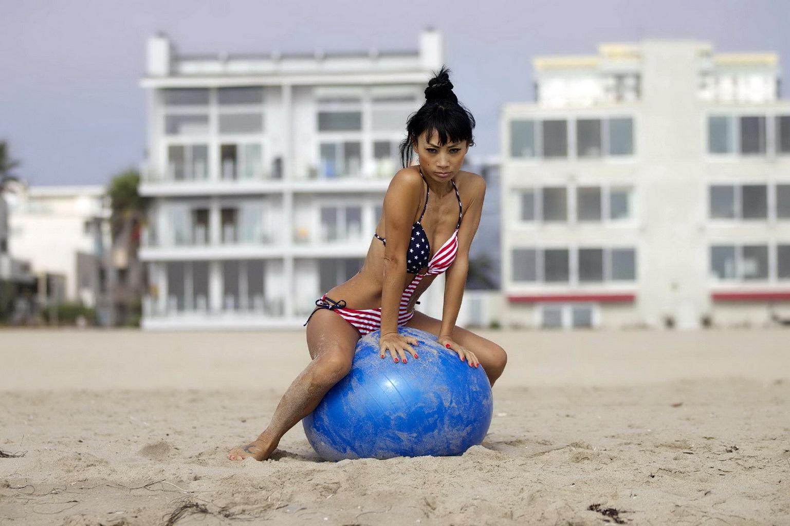 10P Bai Ling in stars  stripes monokini humping a pilates ball on a beach in LA