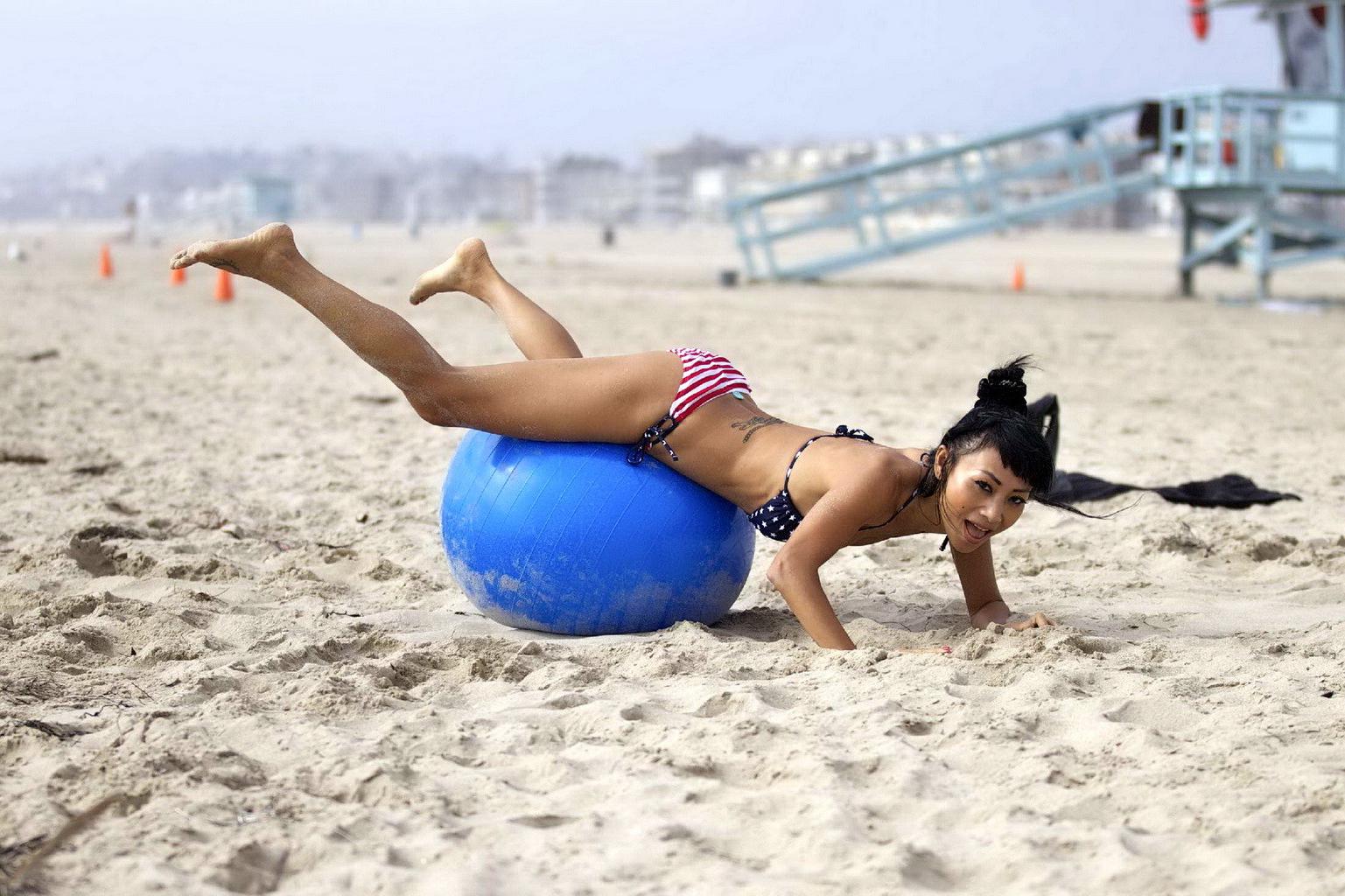 10P Bai Ling in stars  stripes monokini humping a pilates ball on a beach in LA