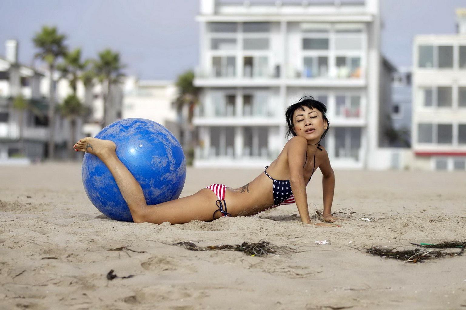 10P Bai Ling in stars  stripes monokini humping a pilates ball on a beach in LA
