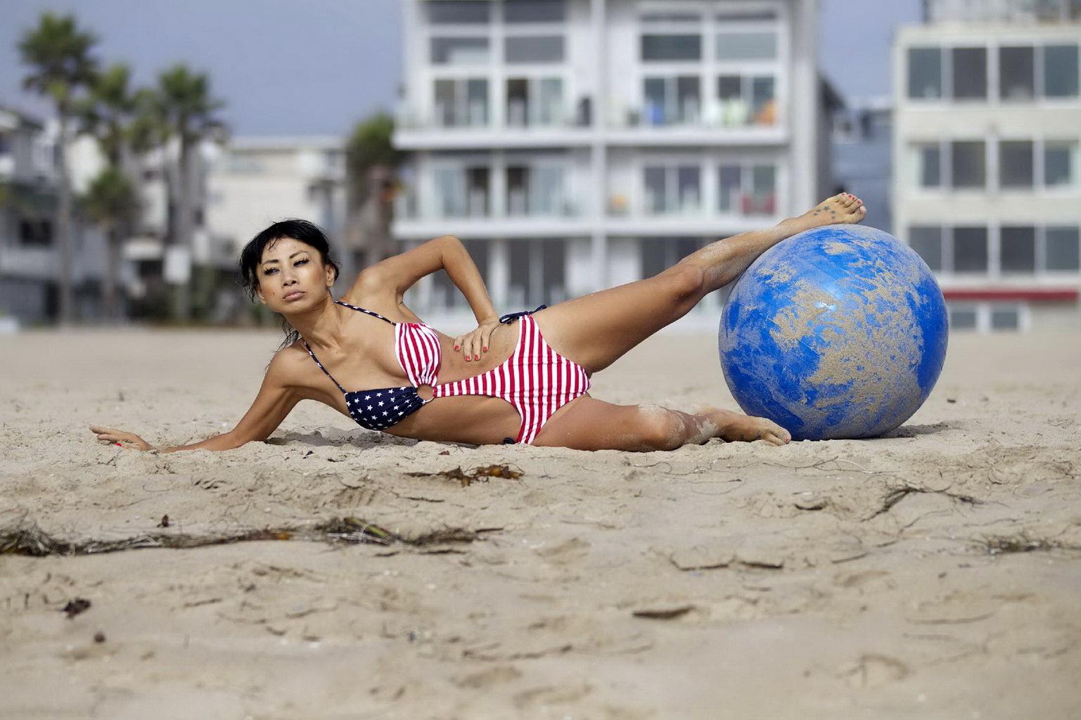 10P Bai Ling in stars  stripes monokini humping a pilates ball on a beach in LA