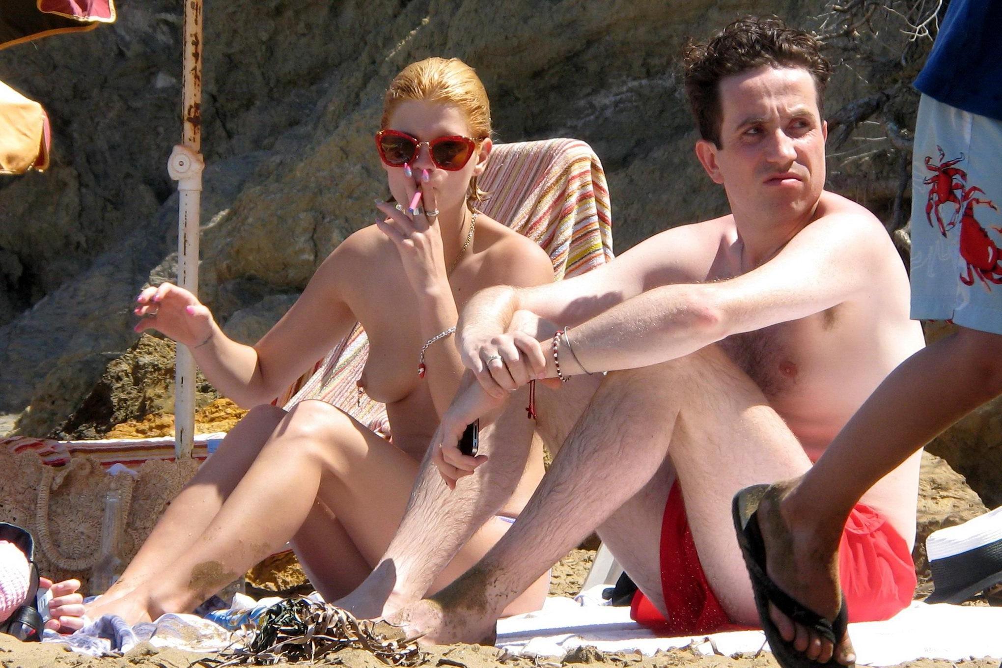 10P Pixie Geldof tanning topless on a beach in Ibiza, Spain