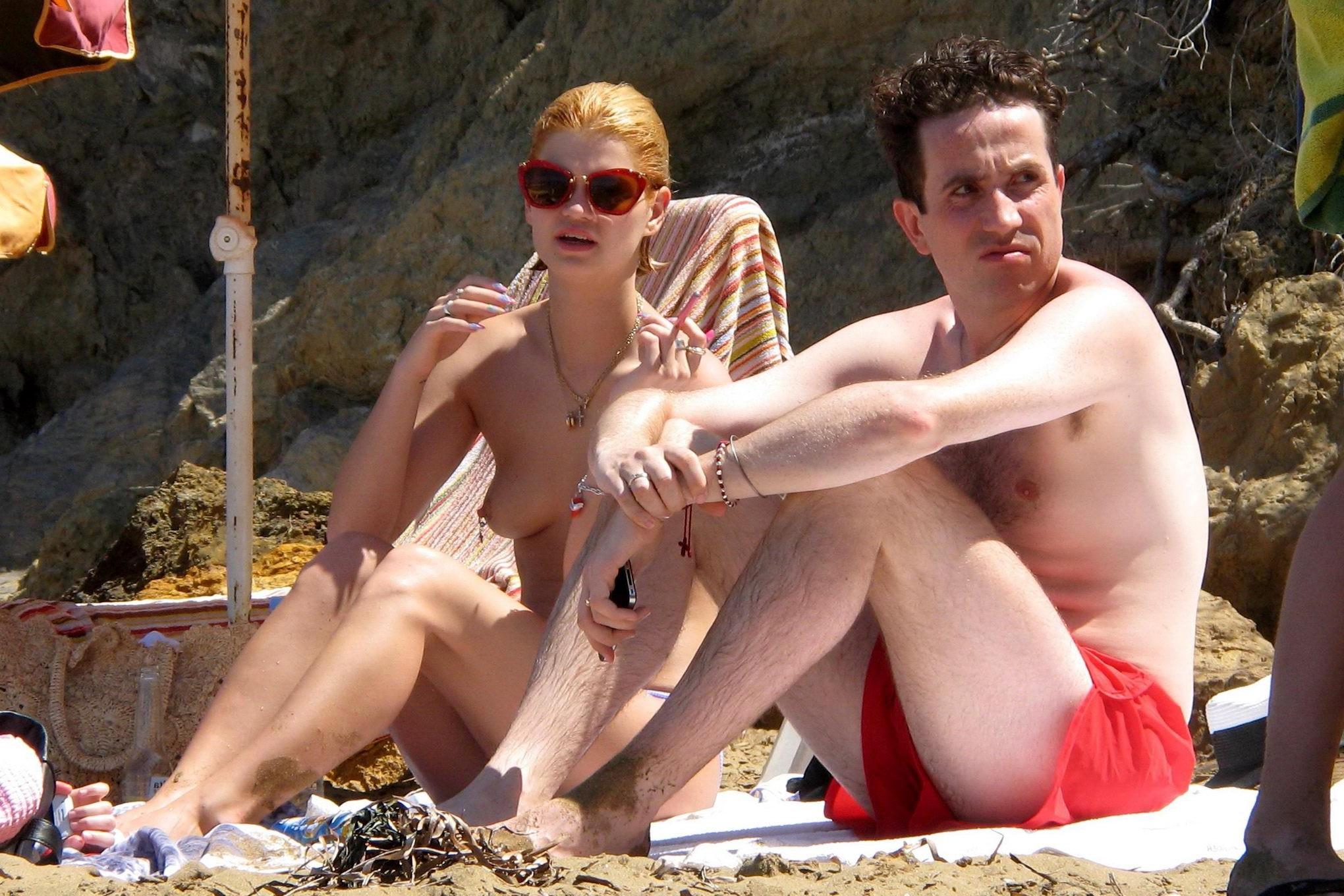 10P Pixie Geldof tanning topless on a beach in Ibiza, Spain