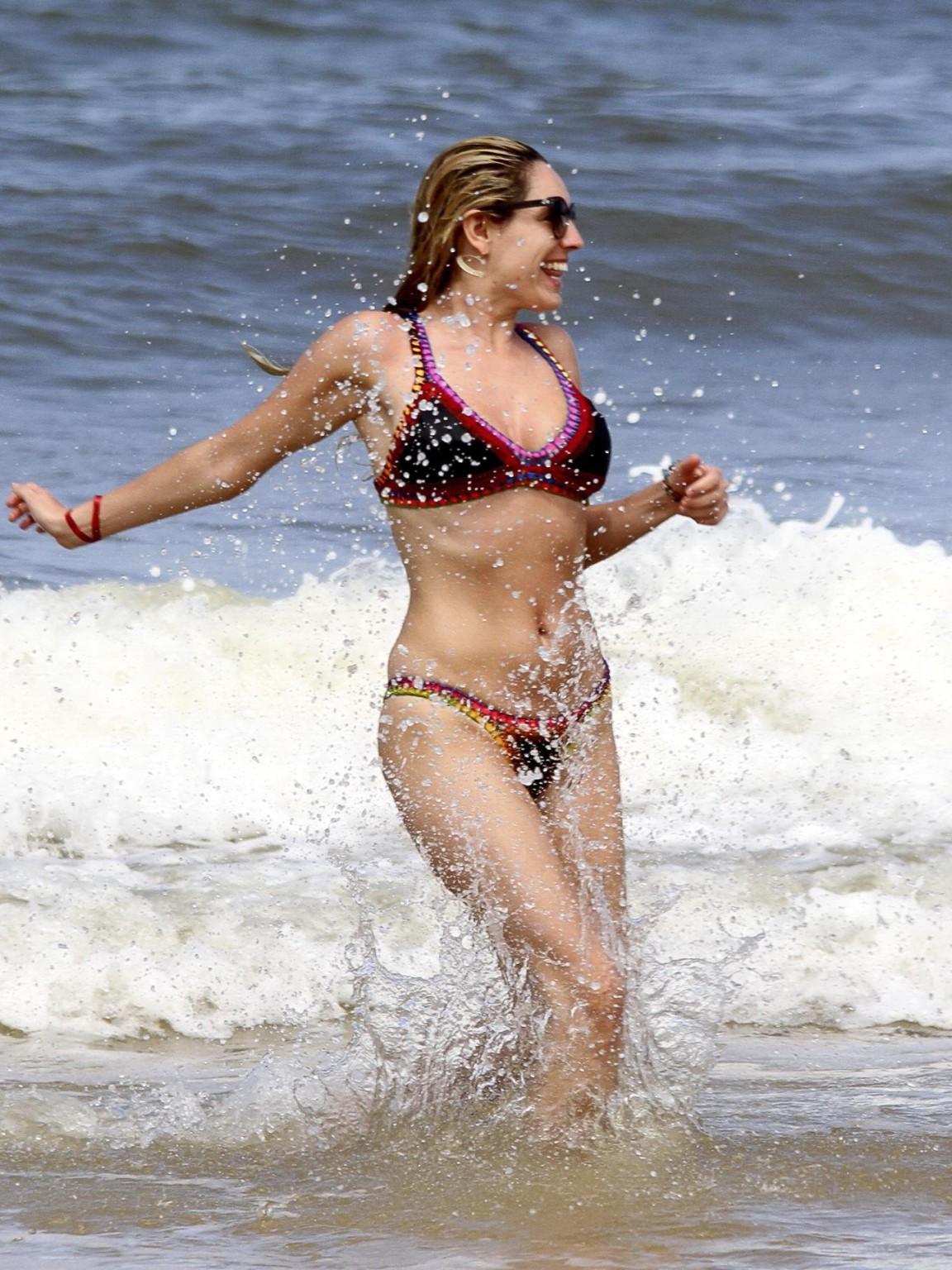 16P Kelly Brook showing off her curvy bikini body on a beach in Ibiza