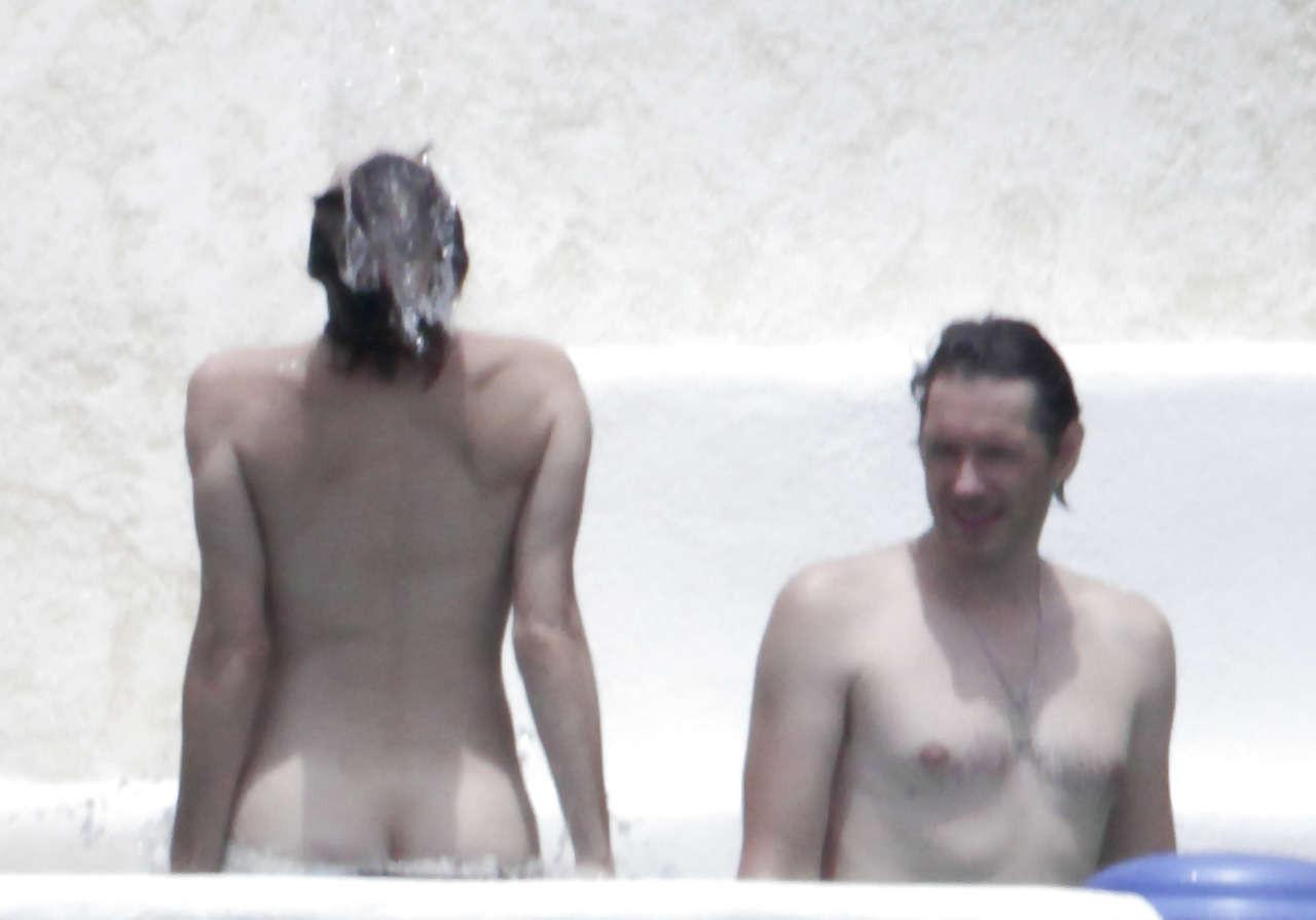 16P Milla Jovovich caught topless in pool by paparazzi and giving them middle finger
