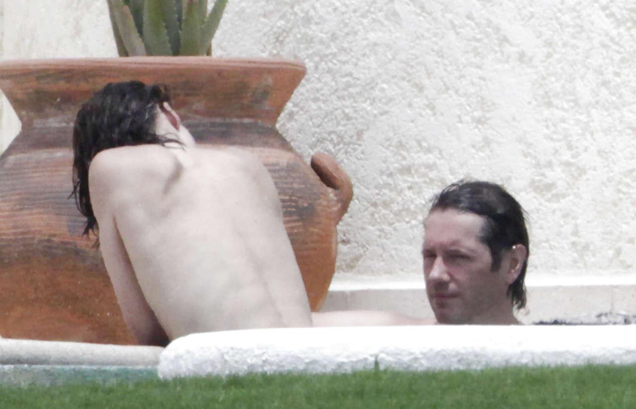 16P Milla Jovovich caught topless in pool by paparazzi and giving them middle finger