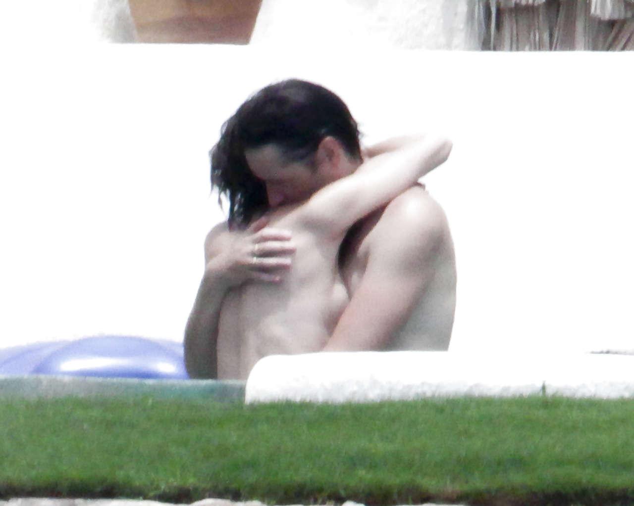 16P Milla Jovovich caught topless in pool by paparazzi and giving them middle finger