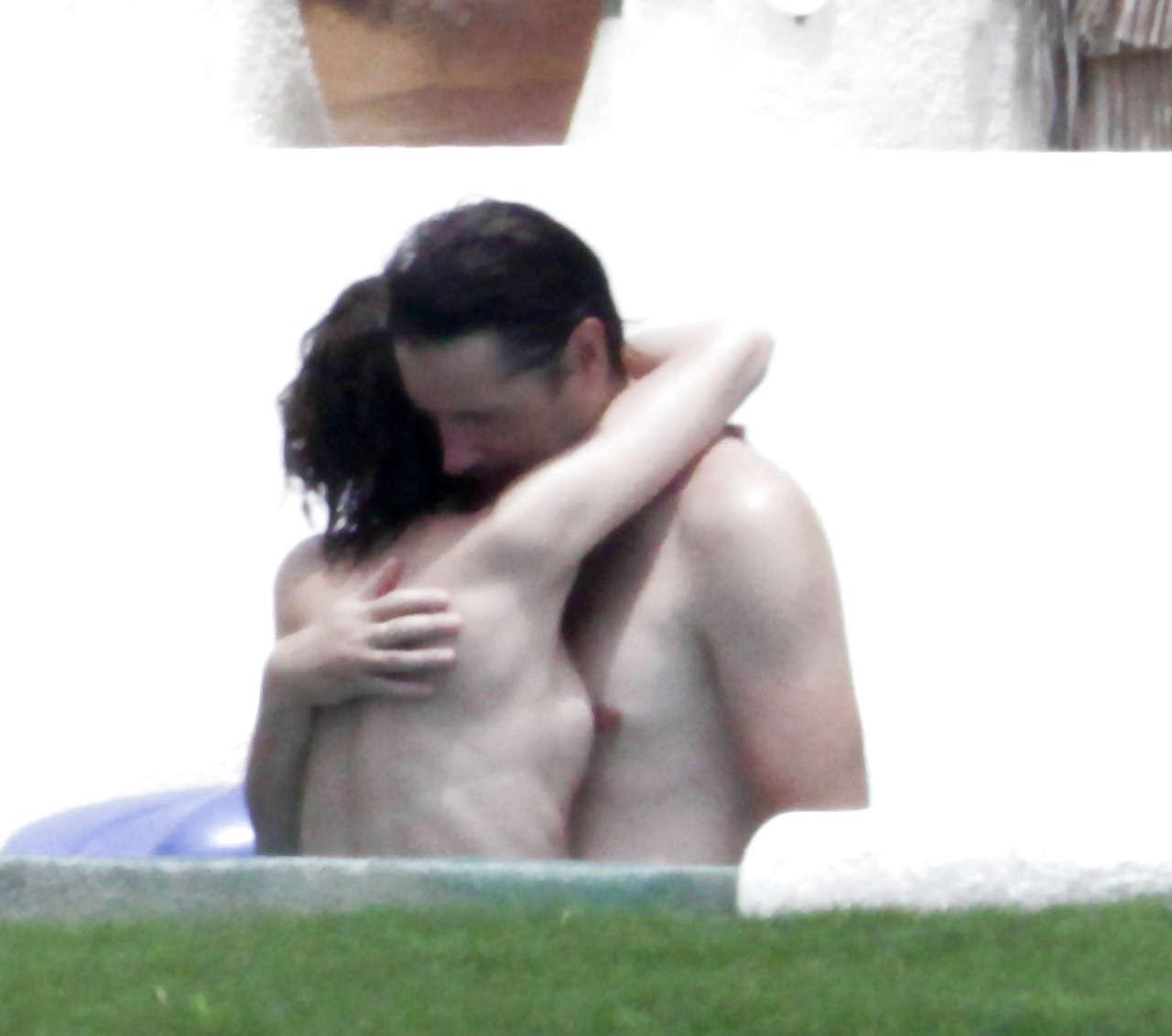 16P Milla Jovovich caught topless in pool by paparazzi and giving them middle finger