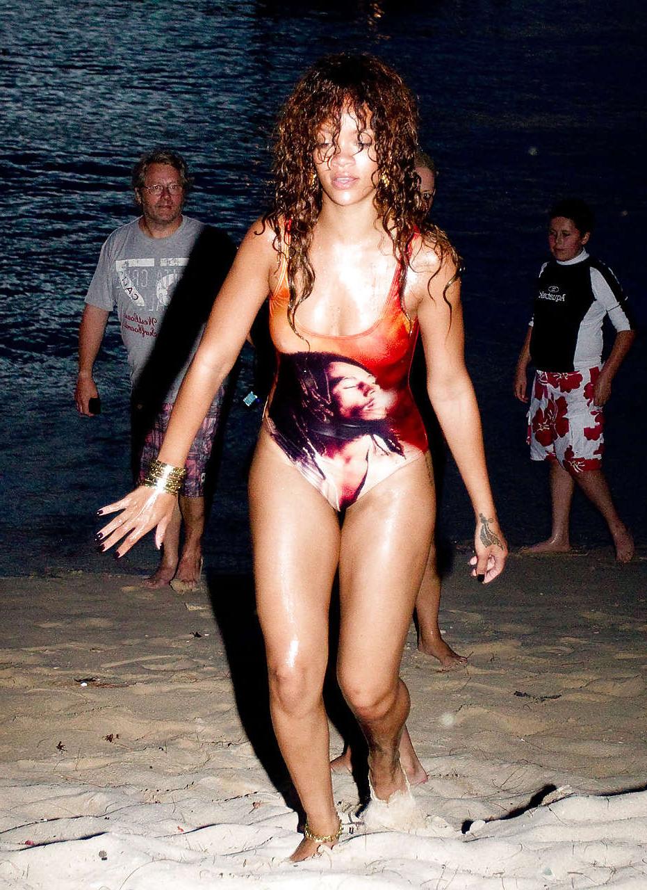 16P Rihanna all wet and sexy in swimsuit on beach caught by paparazzi