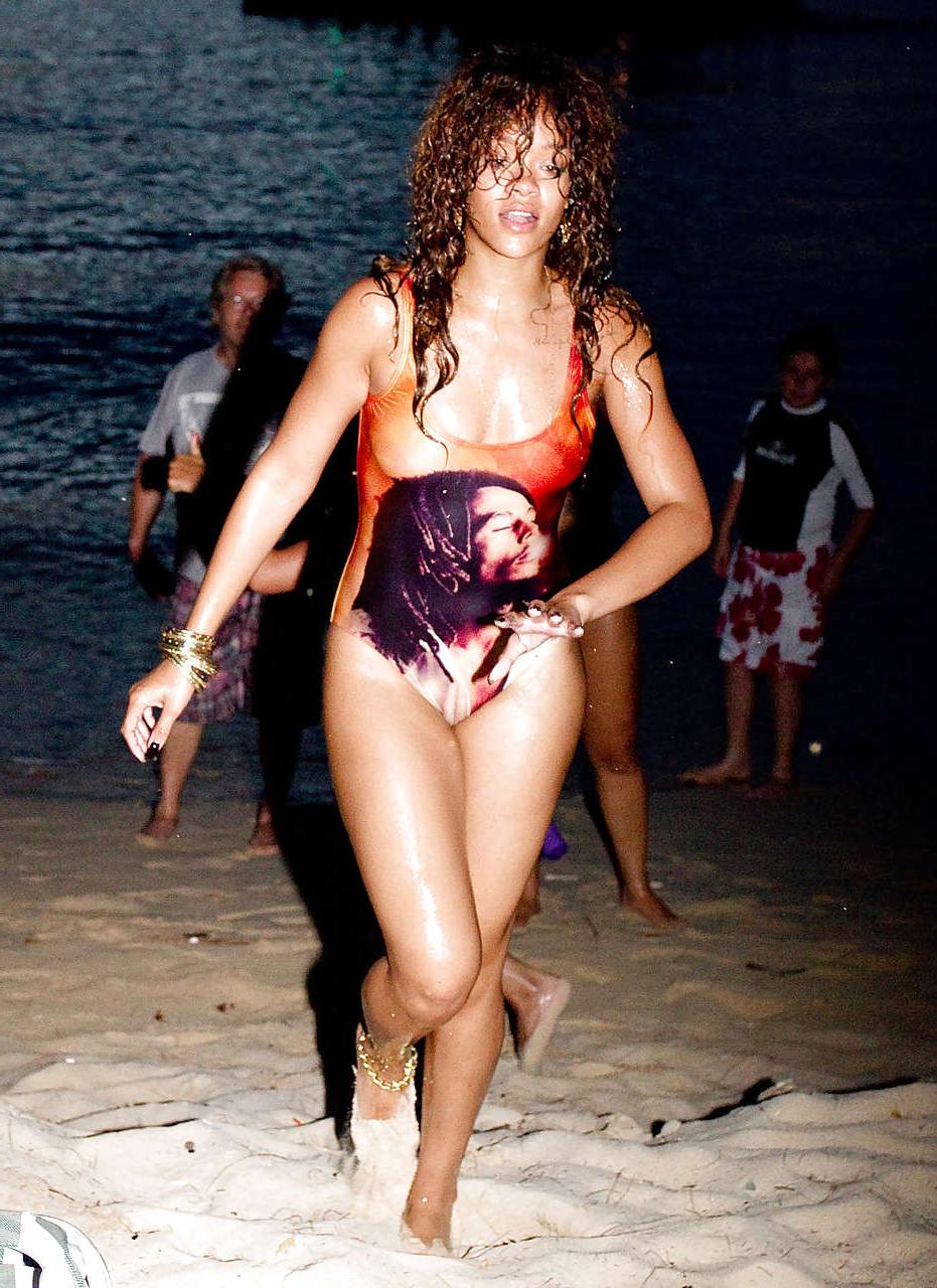 16P Rihanna all wet and sexy in swimsuit on beach caught by paparazzi