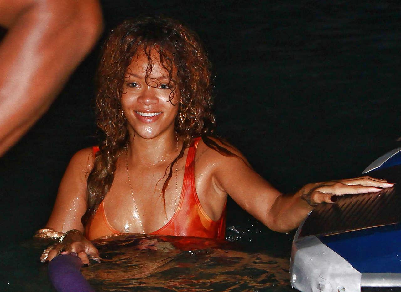 16P Rihanna all wet and sexy in swimsuit on beach caught by paparazzi