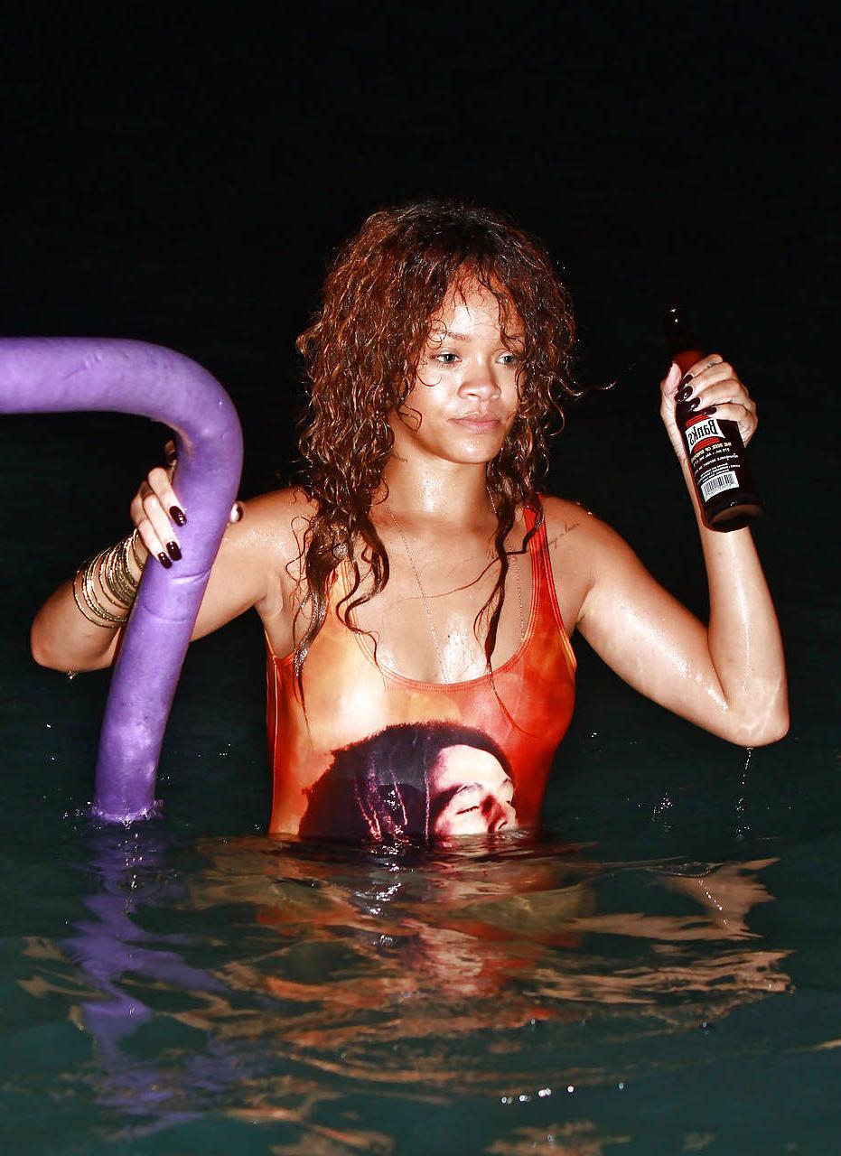 16P Rihanna all wet and sexy in swimsuit on beach caught by paparazzi