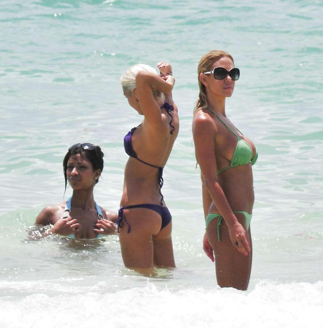 16P Shauna Sand showing her great ass in tiny green bikini caught on beach