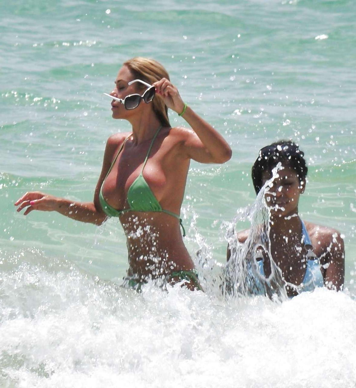 16P Shauna Sand showing her great ass in tiny green bikini caught on beach
