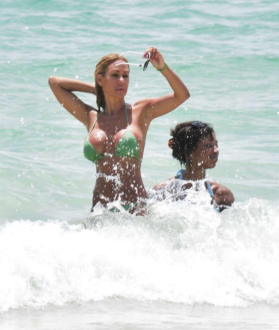16P Shauna Sand showing her great ass in tiny green bikini caught on beach