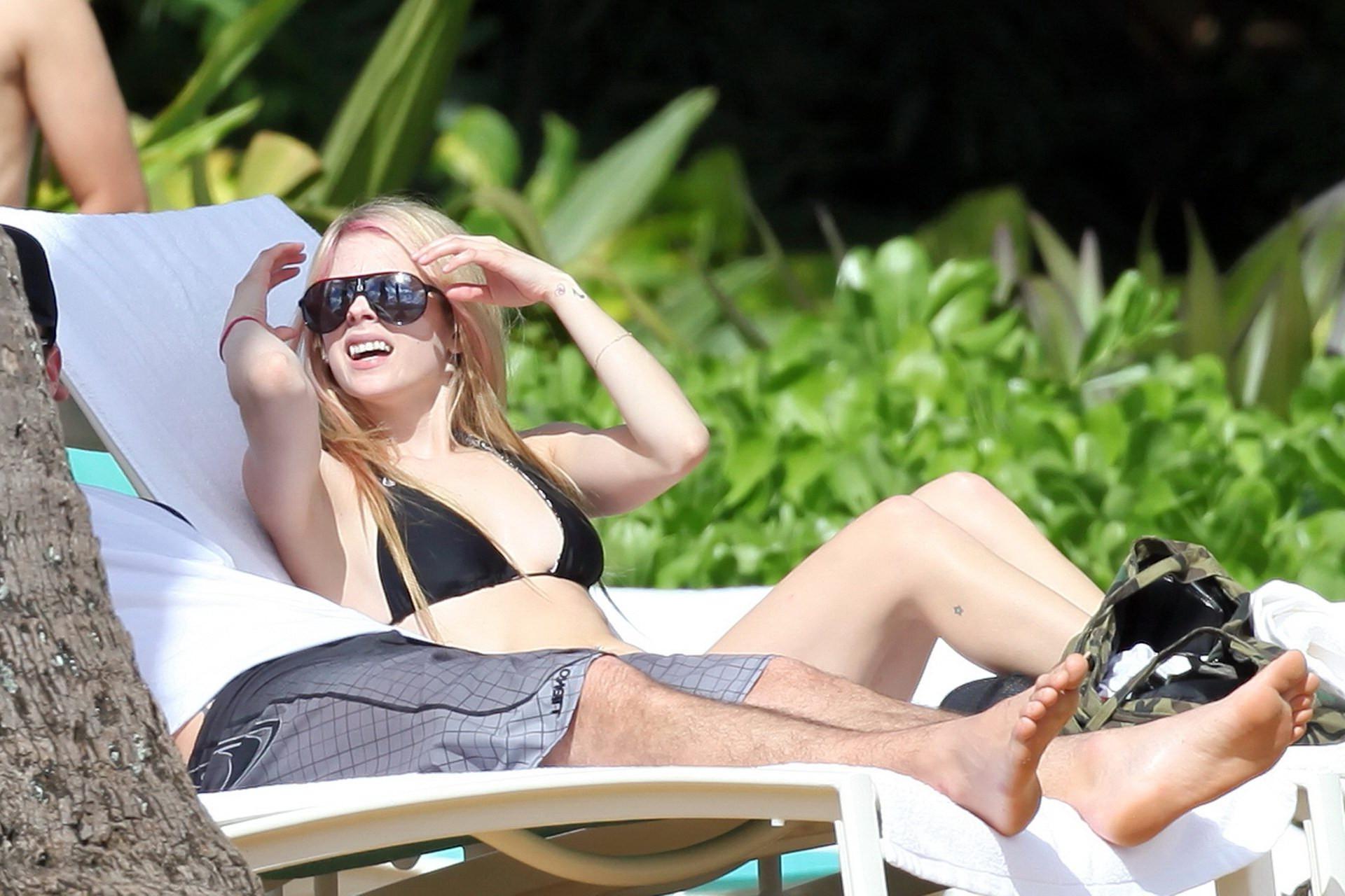 13P Avril Lavigne caught tanning in Hawaii wearing sexy black bikini