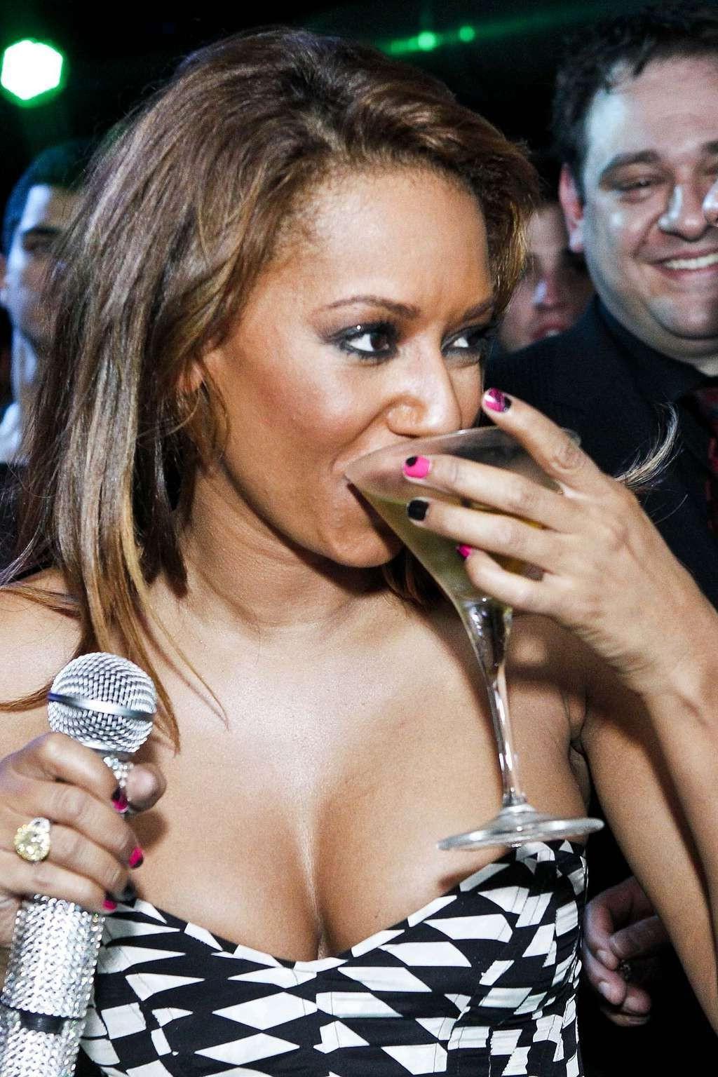 10P Melanie Brown putting tits in first plan in cleavy outfit and flashing panties