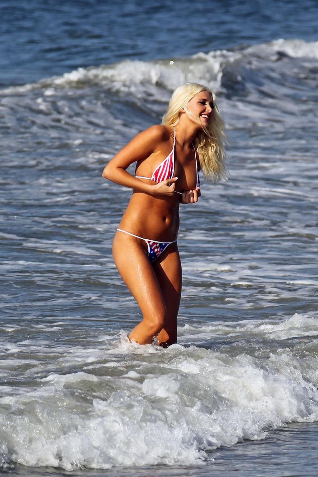 15P Karissa Shannon posing in American flag thong bikini on Malibu beach