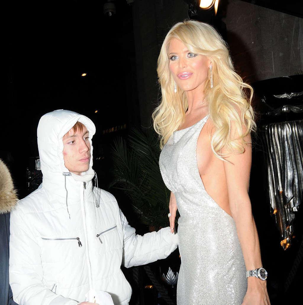 16P Victoria Silvstedt posing and showing sexy and huge tits in skirt