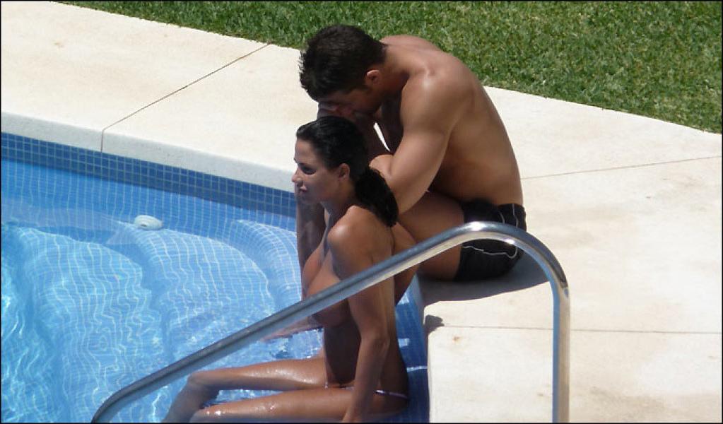 15P Katie Price caught topless while she sunbathing