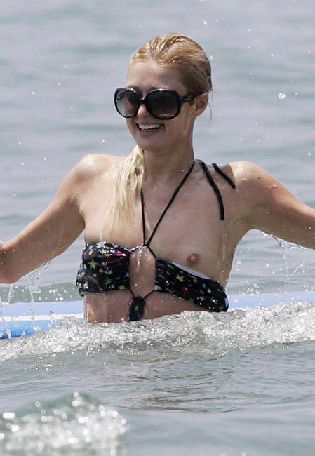 16P Celeb superstar Paris Hilton shows perky tits in the sea