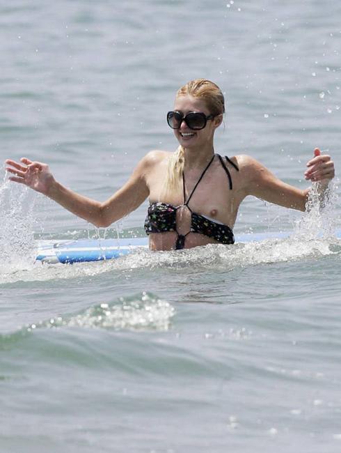 16P Celeb superstar Paris Hilton shows perky tits in the sea