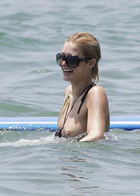 16P Celeb superstar Paris Hilton shows perky tits in the sea
