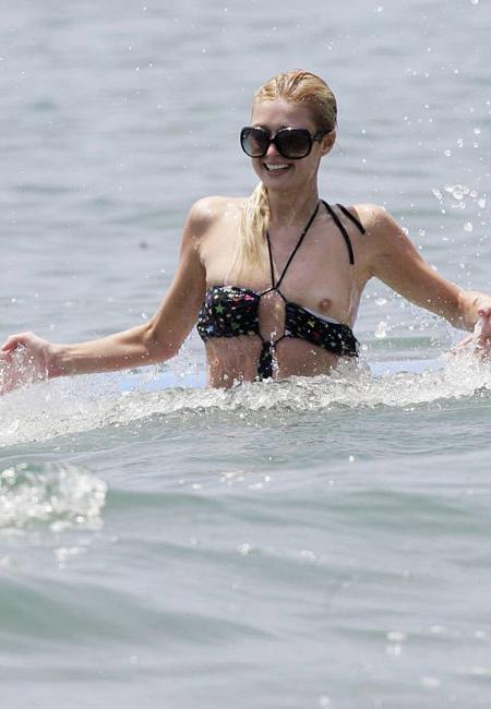 16P Celeb superstar Paris Hilton shows perky tits in the sea