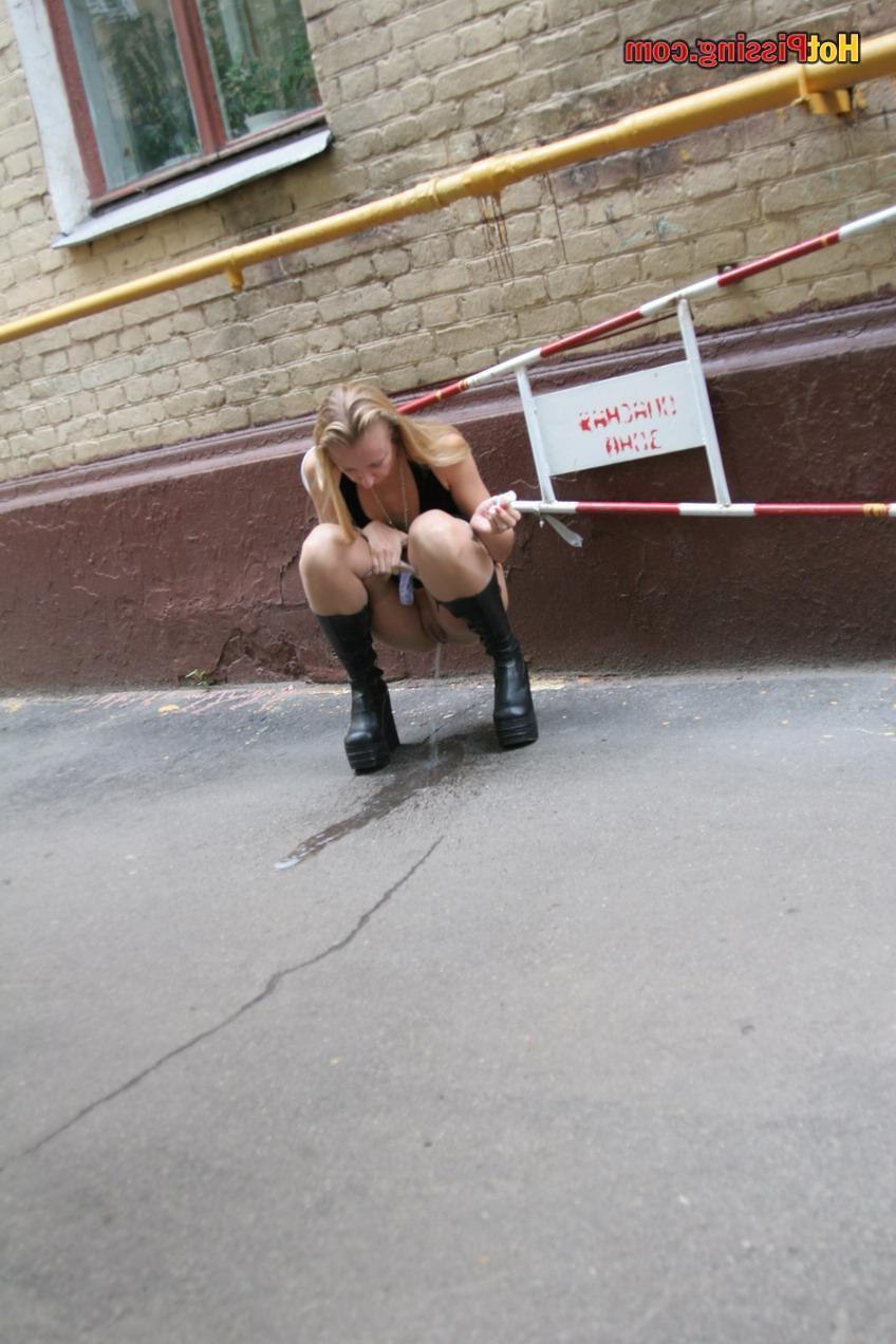 15P Gothic lady in black dress and platform boots does a pee in the street