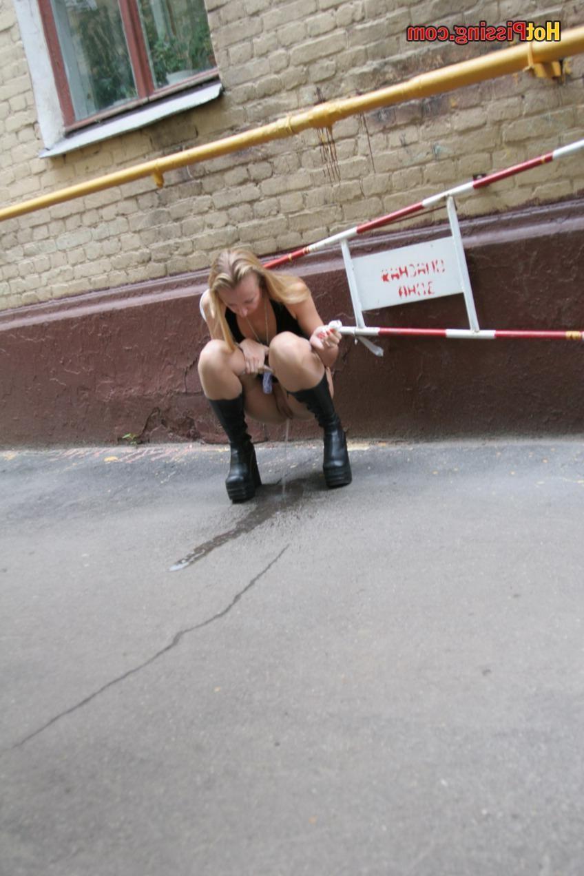 15P Gothic lady in black dress and platform boots does a pee in the street