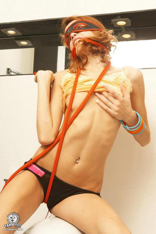 17P Young small titted redhead lady in a mask showing hot striptease