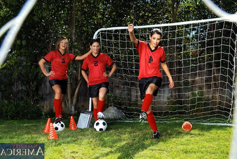 14P Three sexy girls warm up on the soccer field