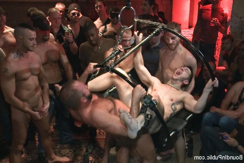 15P A hot stud is tied up and fucked in front of 100 horny men