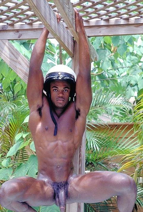 20P Naked ebony gay loves flashing his huge cock while posing