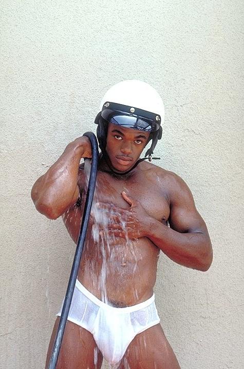 20P Naked ebony gay loves flashing his huge cock while posing