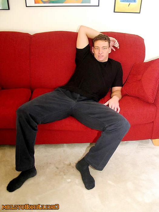 15P Sexy amateur gay stud undressing on a sofa