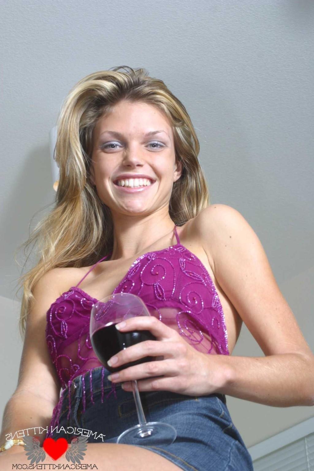 18P Ashley is in the kitchen again wearing a sheer top and jean skirt enjoying a gla