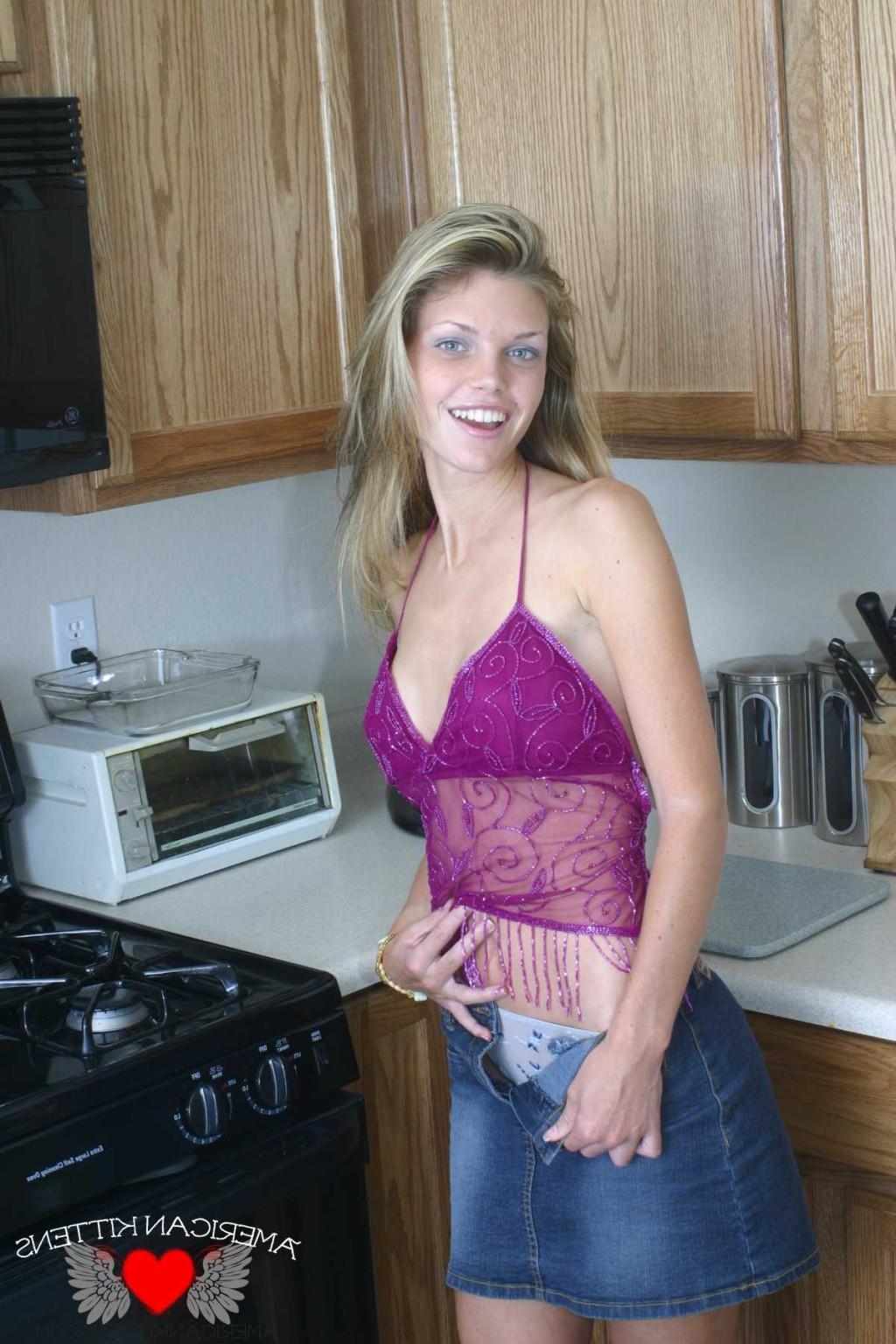 18P Ashley is in the kitchen again wearing a sheer top and jean skirt enjoying a gla