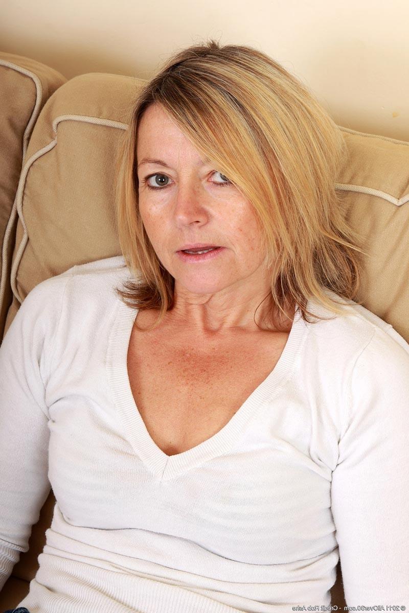 15P Horny blonde mature strips naked on her couch