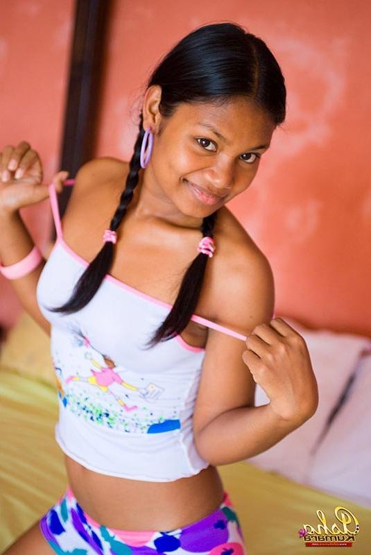 15P Sexy Indian girl Asha Kumara lays in bed with buns exposed