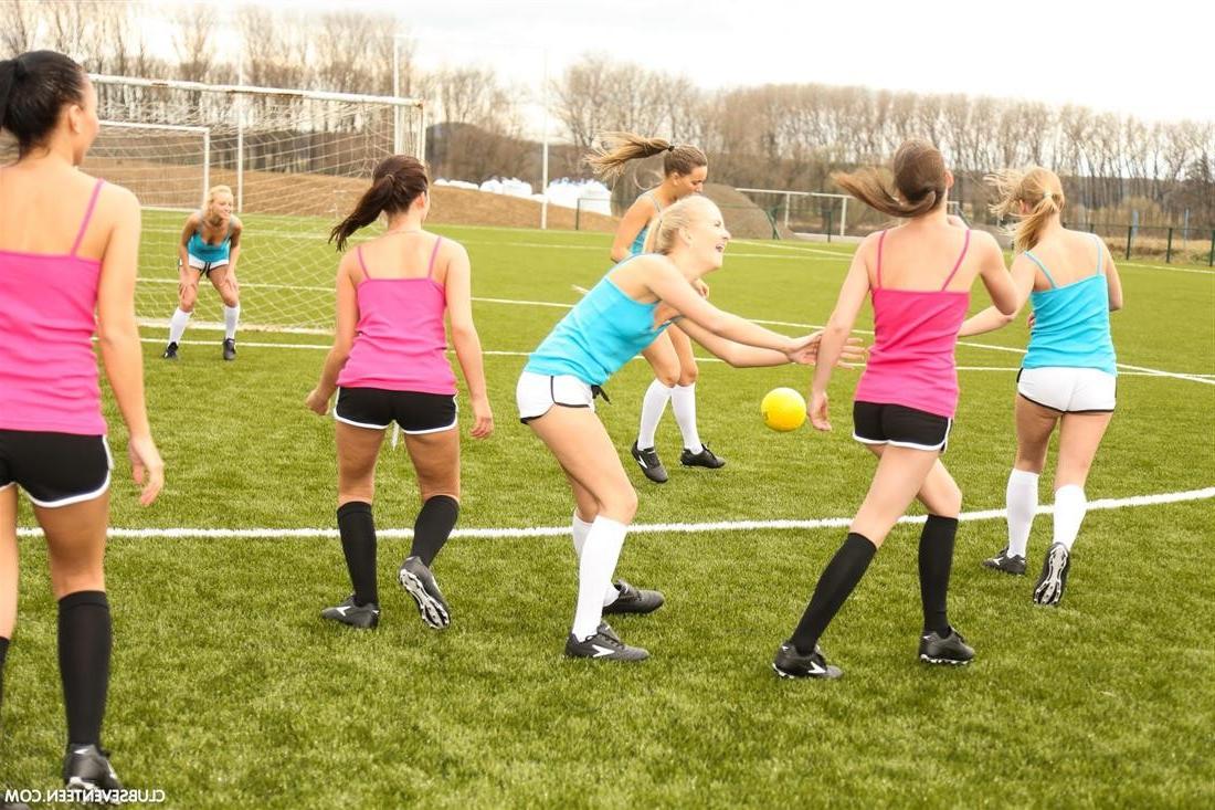 15P Naked girl soccer players posing together on the field