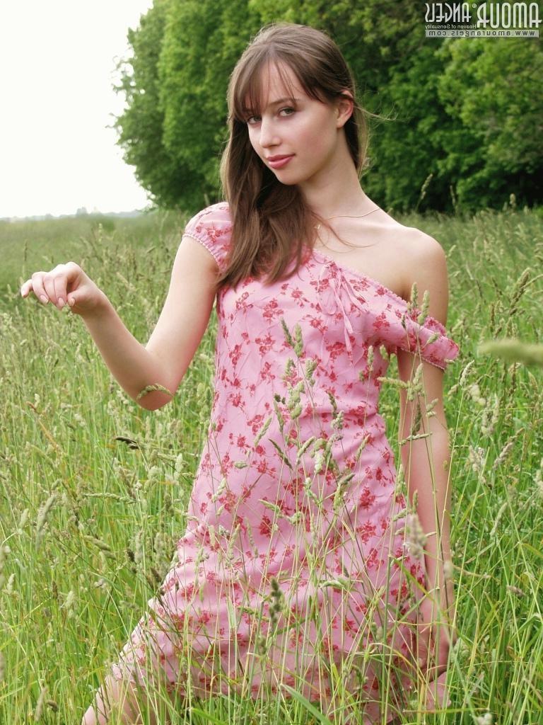 15P Small titted eighteen year old poses in the grass