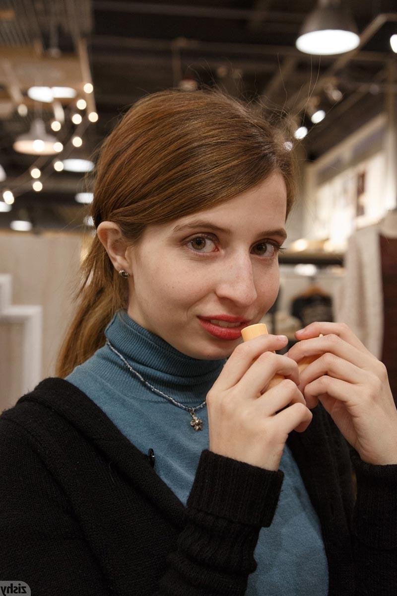 12P Cute redhead shows perky tits in the store